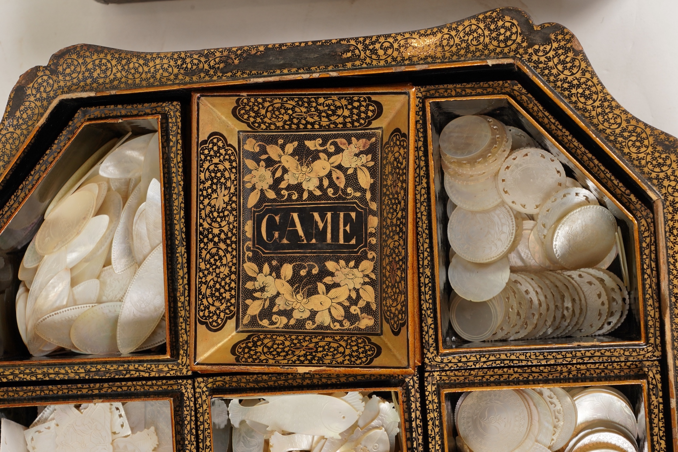 Two Chinese gilt decorated black lacquer games boxes, containing numerous mother-of-pearl counters, 19th century